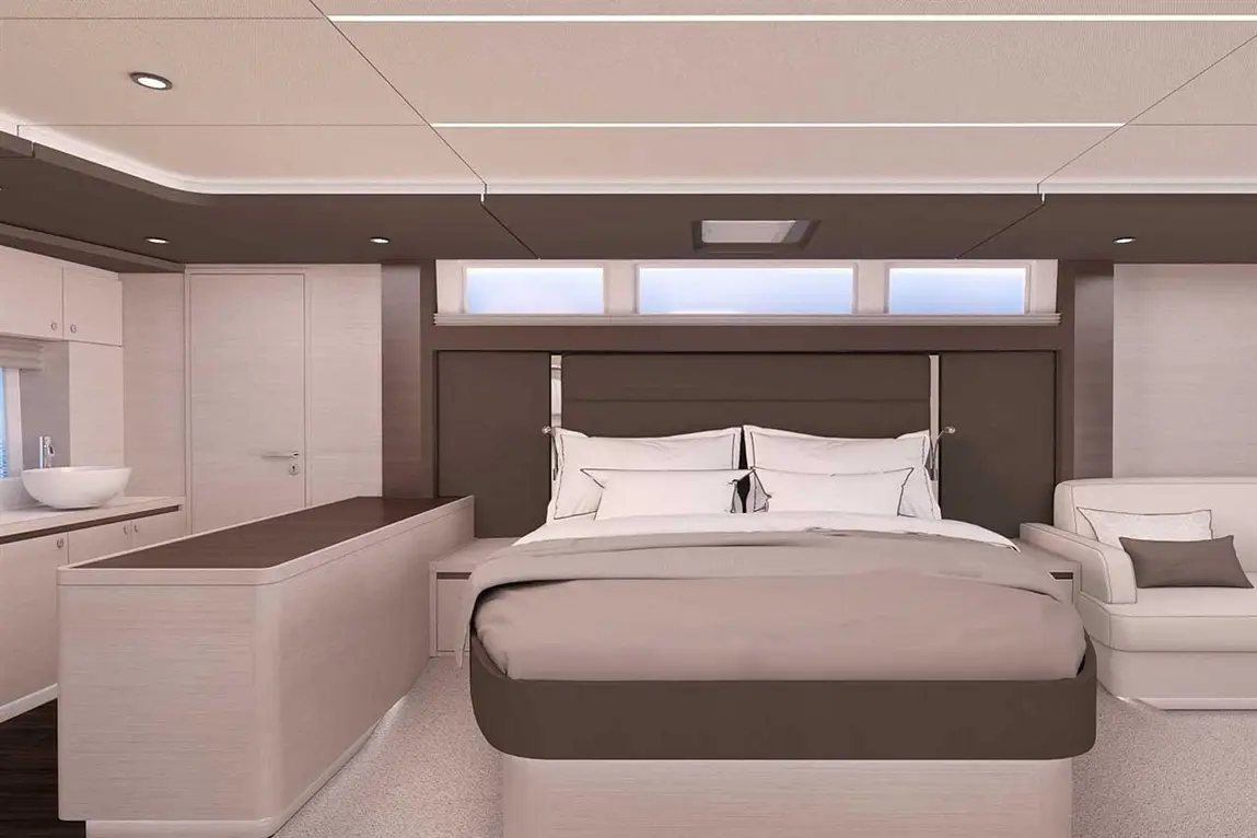 Modern bedroom featuring a large bed with plush bedding, side table, and a white lounge chair against a sleek interior design.